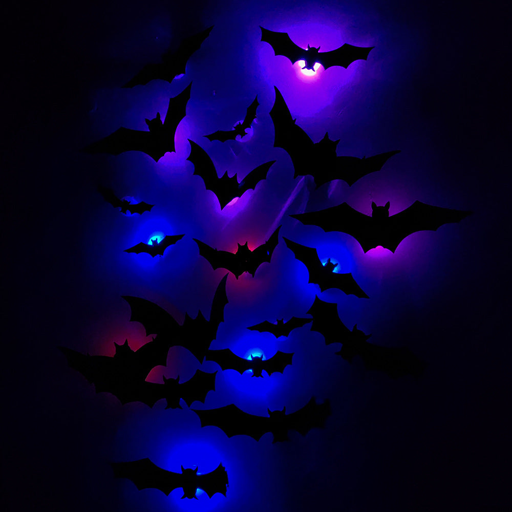 LED bat wall decals glowing blue and violet on a dark wall at night