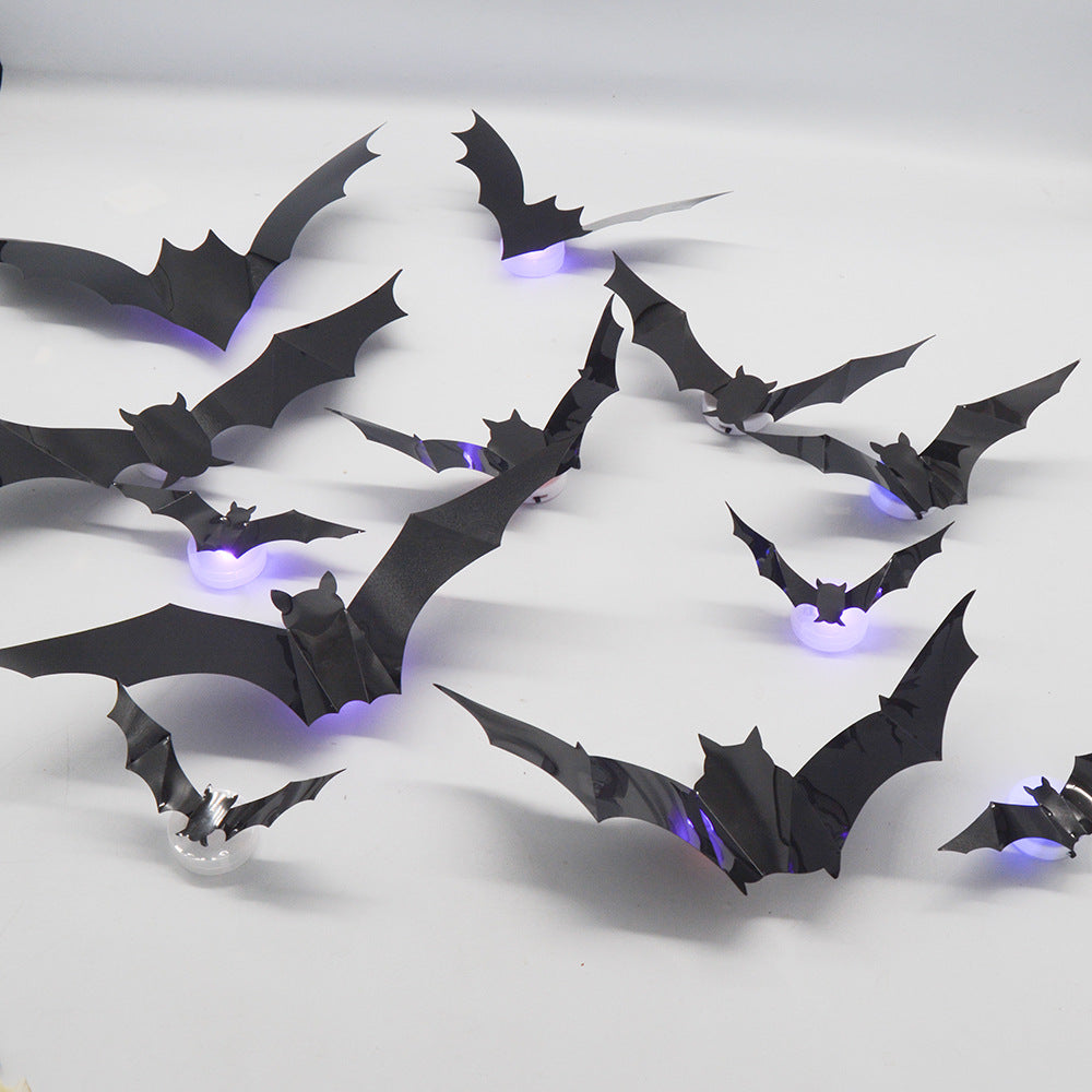3D bats with folded-out wings and LED lights on a light-colored wall