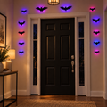 One complete 12-piece LED bat set glowing inside a home entryway at night